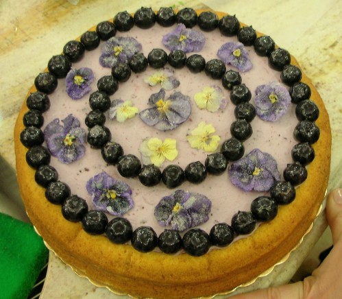 The Baking Architect's Cheesecake with Blueberry Cream, decorated with crystallized pansies